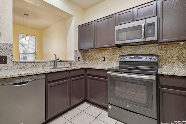 kitchen featuring dark brown cabinetry, sink, decorative backsplash, and stainless steel appliances