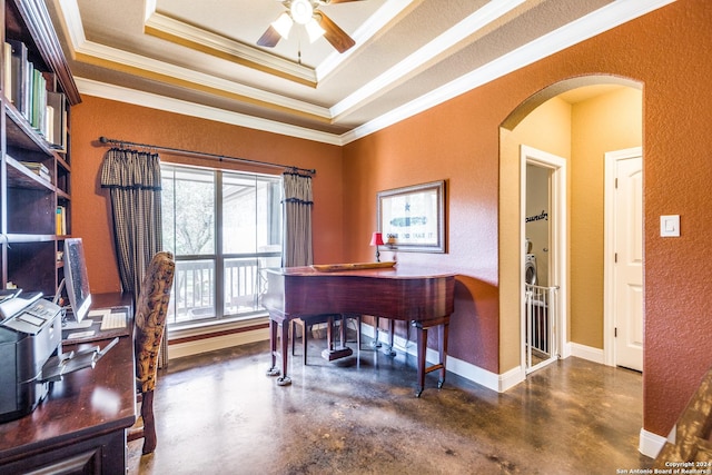 office featuring finished concrete flooring, baseboards, arched walkways, a raised ceiling, and a textured wall