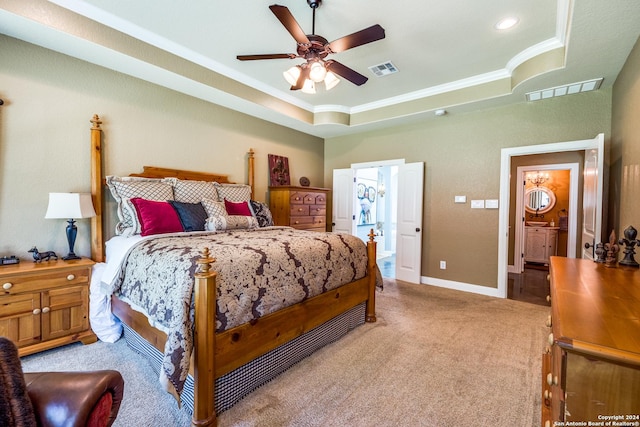 bedroom with carpet floors, a tray ceiling, visible vents, and baseboards