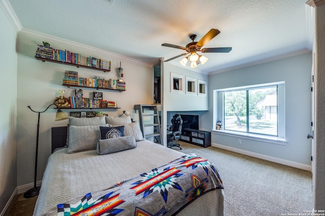 bedroom with baseboards, ceiling fan, ornamental molding, a textured ceiling, and carpet flooring