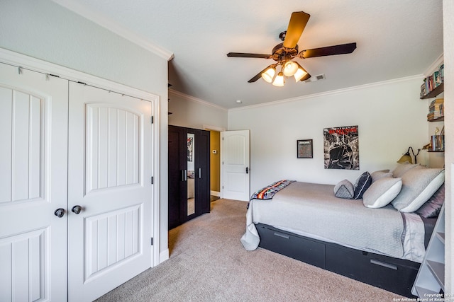 bedroom with ornamental molding, a closet, visible vents, and light carpet