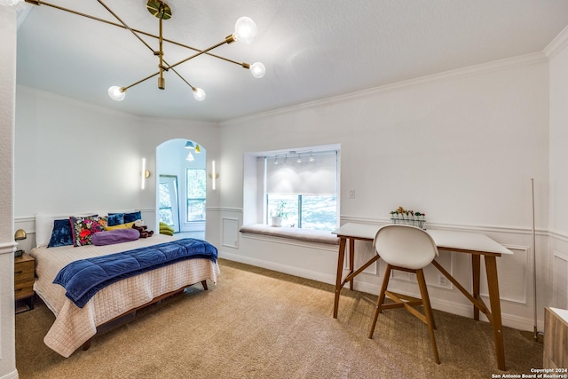 carpeted bedroom with arched walkways, ornamental molding, wainscoting, and a decorative wall