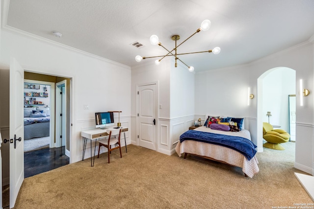 bedroom featuring visible vents, arched walkways, a wainscoted wall, ornamental molding, and carpet