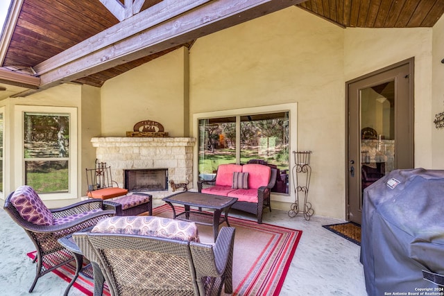 view of patio featuring grilling area and an outdoor living space with a fireplace