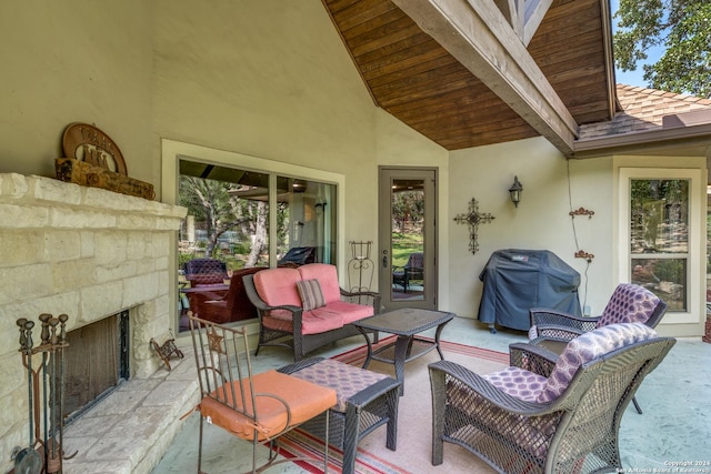 view of patio / terrace with an outdoor living space with a fireplace and area for grilling