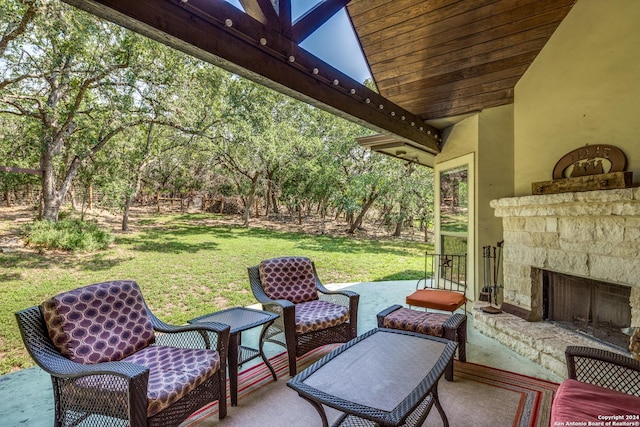 view of patio featuring an outdoor stone fireplace