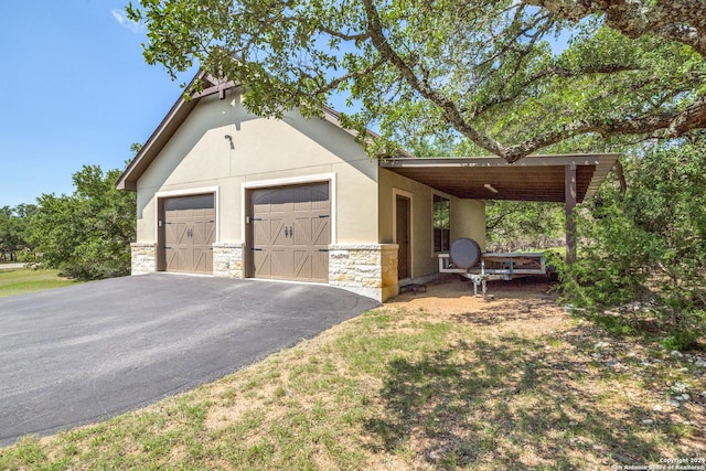 garage featuring aphalt driveway