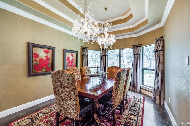 dining space featuring baseboards, a chandelier, a tray ceiling, and a textured wall