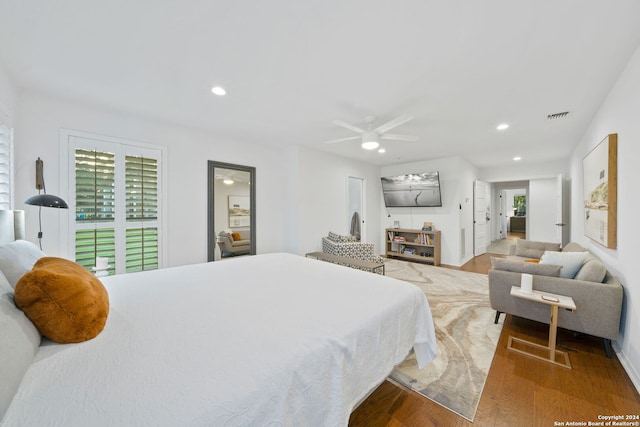 bedroom with ceiling fan and wood-type flooring