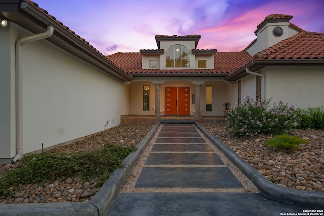 view of exterior entry at dusk