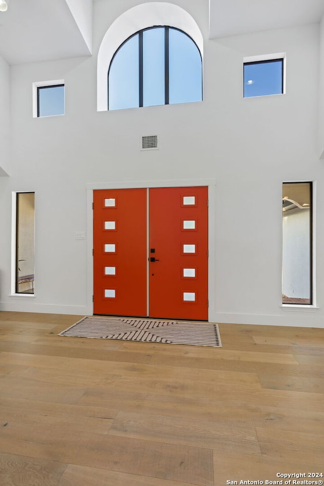 foyer featuring a high ceiling and light hardwood / wood-style flooring