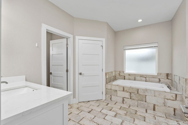 bathroom featuring vanity and a bath