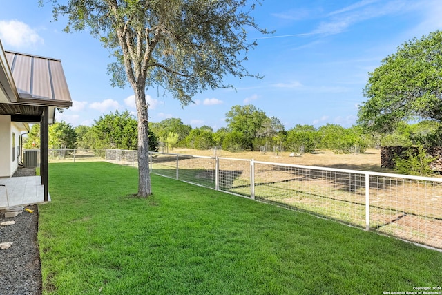 view of yard featuring fence and a rural view