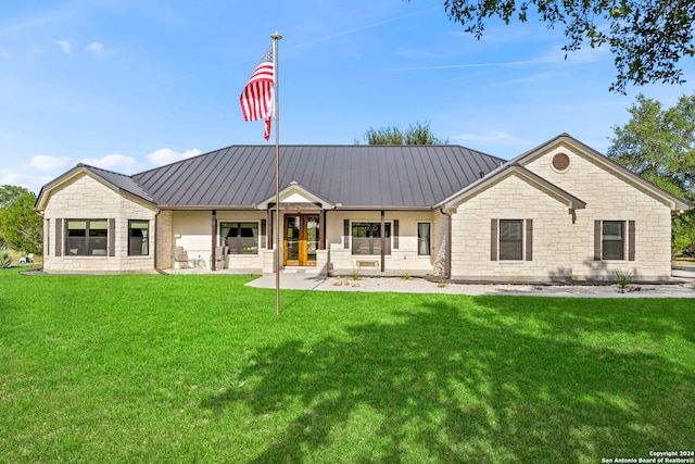 exterior space with metal roof, a porch, a standing seam roof, and a lawn