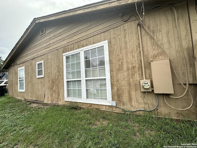 view of property exterior featuring a lawn