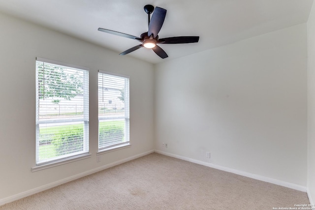 carpeted empty room featuring ceiling fan