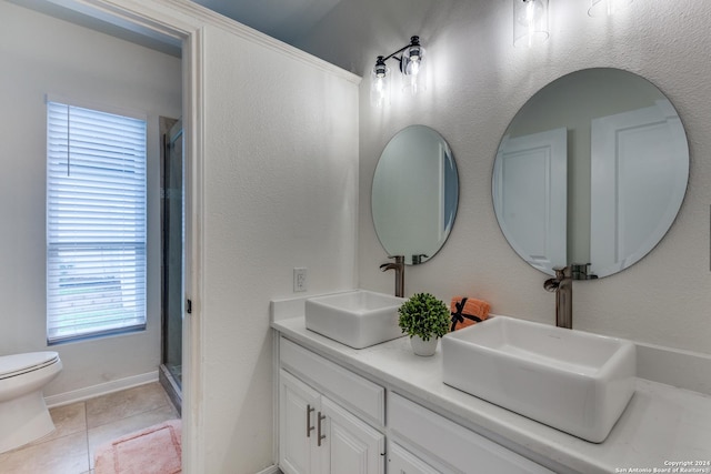 bathroom featuring walk in shower, tile patterned floors, toilet, and vanity