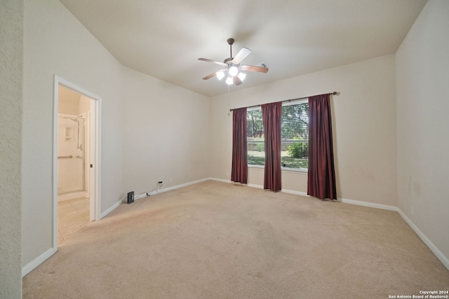 empty room featuring light carpet and ceiling fan