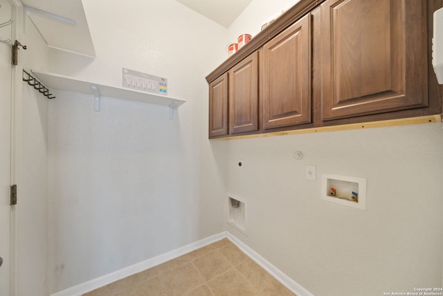 washroom featuring hookup for a washing machine, cabinets, and hookup for an electric dryer