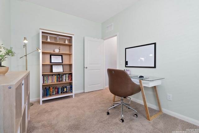 home office with light carpet, baseboards, and visible vents