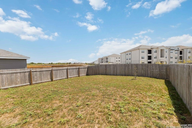 view of yard with a residential view and a fenced backyard