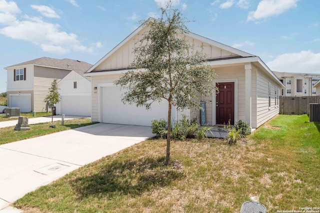 view of front of home with a garage, fence, a front lawn, and board and batten siding