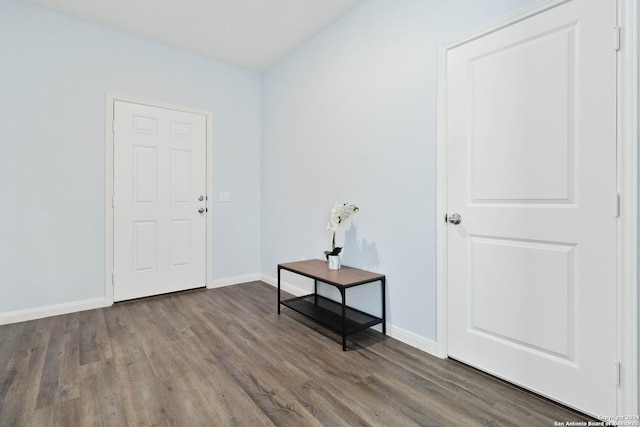 entryway with baseboards and wood finished floors