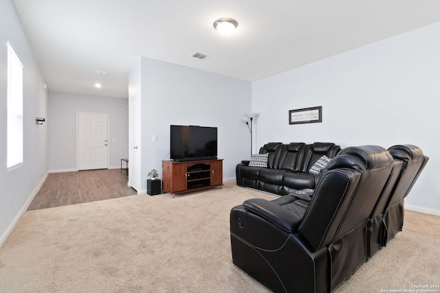 living area with carpet, visible vents, and baseboards