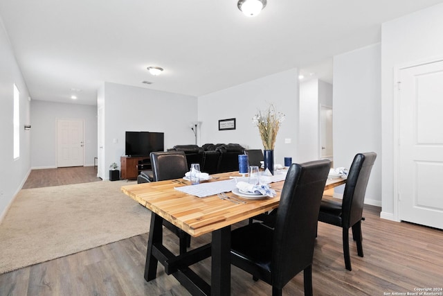 dining area with baseboards and wood finished floors