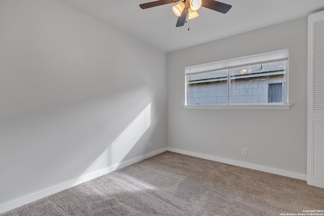 empty room with ceiling fan and carpet flooring