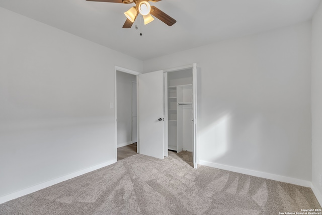 unfurnished bedroom with a closet, carpet floors, and ceiling fan