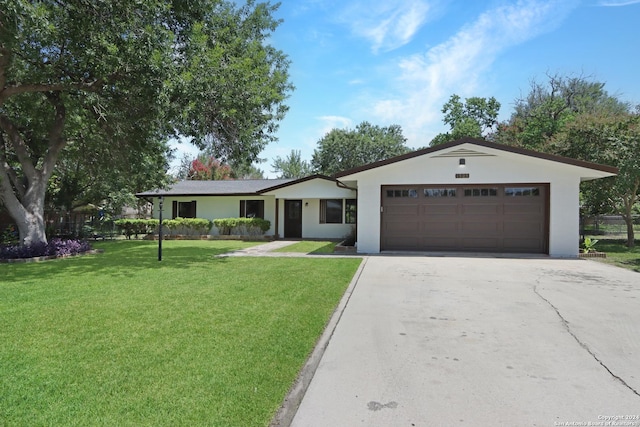 ranch-style home featuring a garage and a front yard