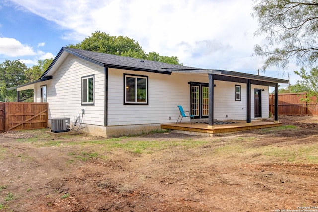 rear view of property featuring central AC unit and a deck