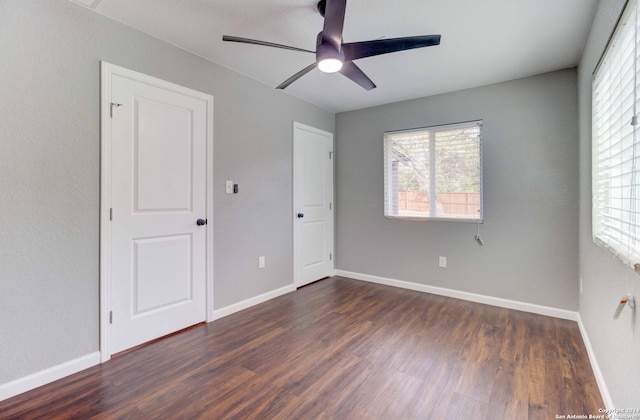 spare room featuring ceiling fan and dark wood-type flooring