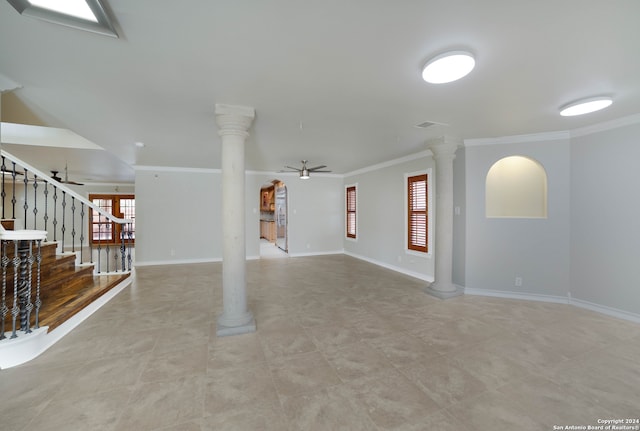 unfurnished living room featuring decorative columns, ceiling fan, and ornamental molding