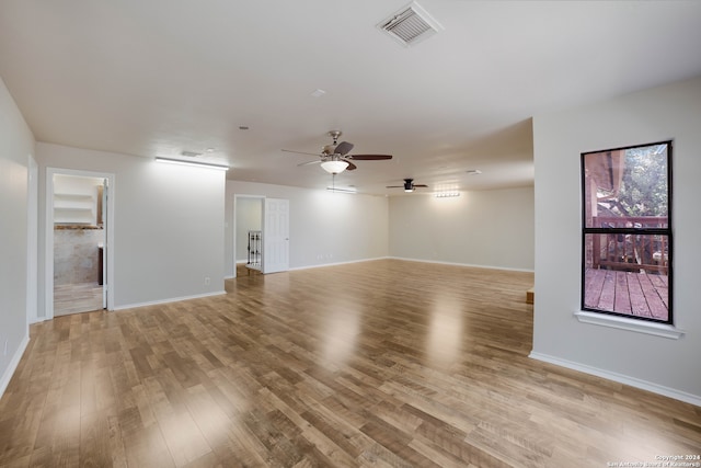 empty room with ceiling fan and light wood-type flooring