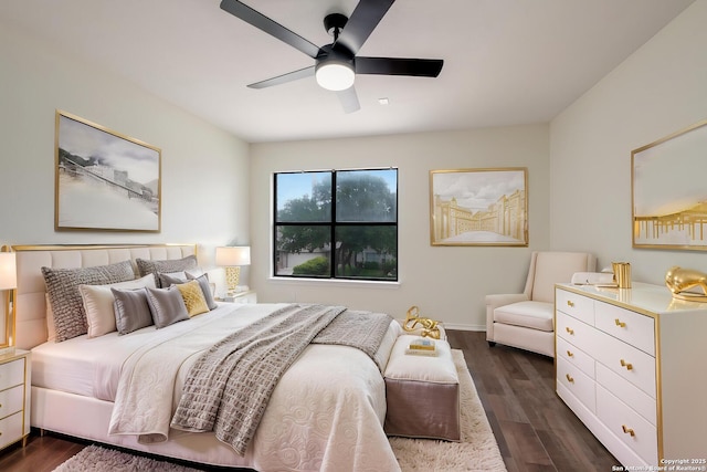 bedroom with dark wood-style floors, ceiling fan, and baseboards
