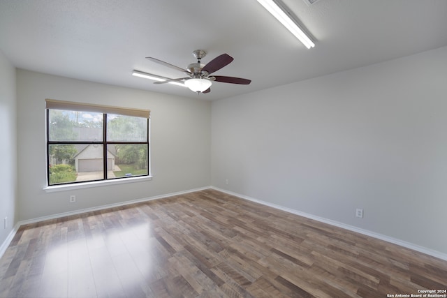 spare room with hardwood / wood-style flooring and ceiling fan