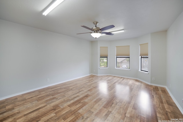 empty room with ceiling fan and light wood-type flooring