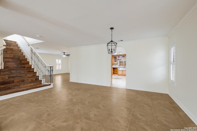 interior space with baseboards, visible vents, stairs, and crown molding