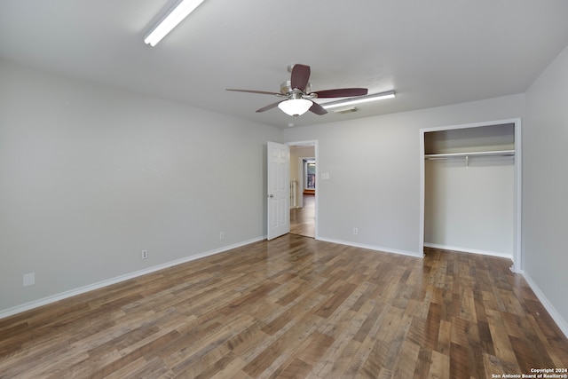 unfurnished bedroom featuring a closet, hardwood / wood-style flooring, and ceiling fan