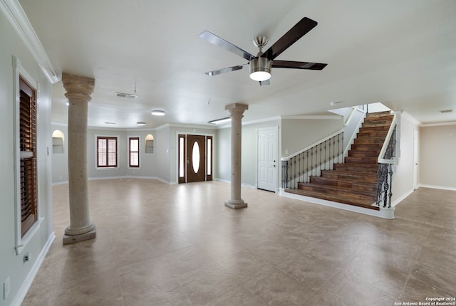 foyer entrance with ceiling fan and ornamental molding