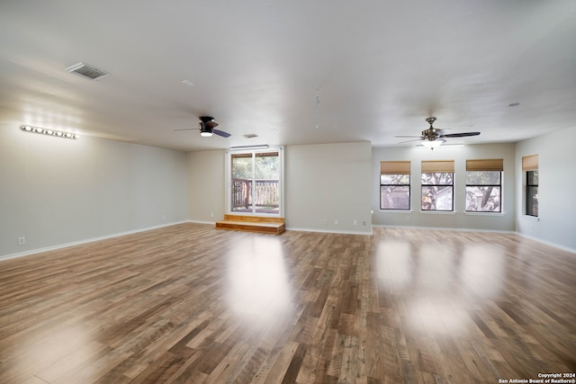 unfurnished living room with hardwood / wood-style flooring and ceiling fan