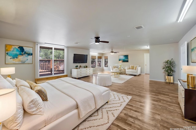 bedroom with baseboards, wood finished floors, and a ceiling fan