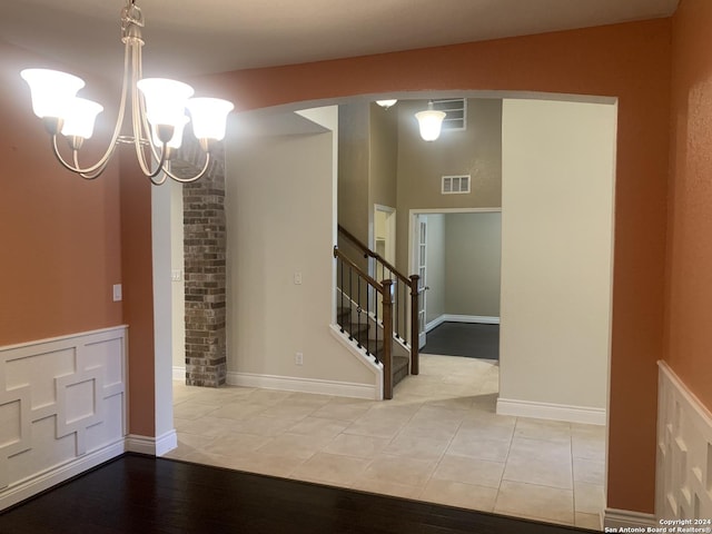 interior space featuring a notable chandelier and light tile patterned floors