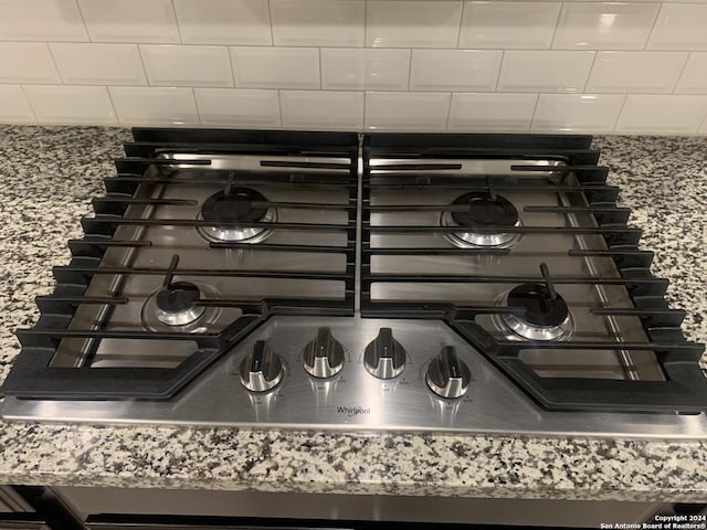 room details featuring stove and stone countertops