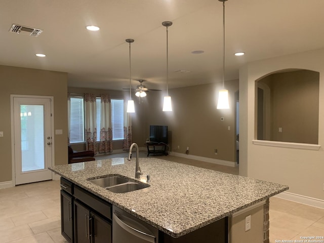 kitchen with sink, dishwasher, light stone counters, a center island with sink, and decorative light fixtures