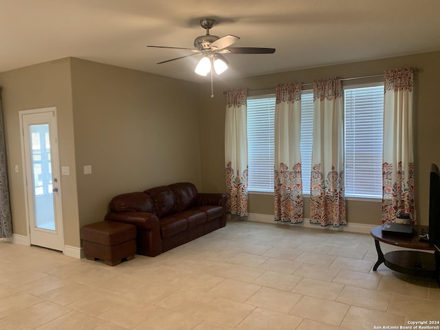 tiled living room featuring ceiling fan