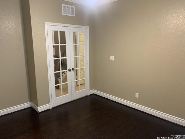 unfurnished room with dark hardwood / wood-style floors and french doors