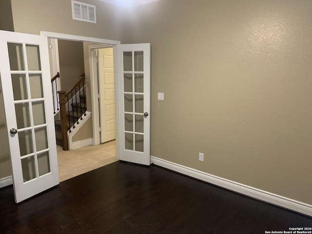 unfurnished room featuring wood-type flooring and french doors